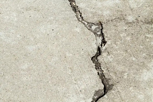 A jagged crack running across an exterior concrete slab.
