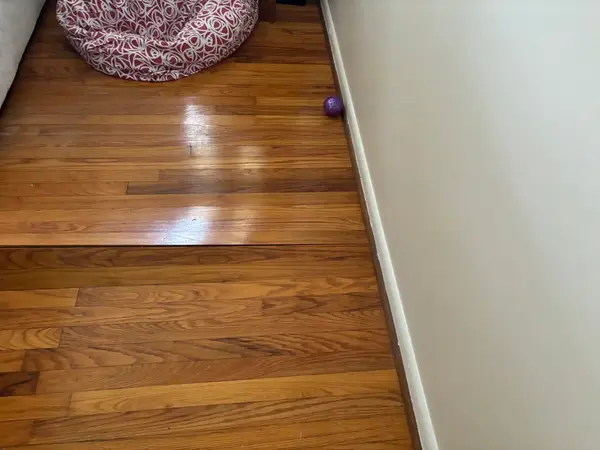 Ground Up Foundation Repair, Waterproofing and Concrete Leveling inspecting sagging hardwood floors due to foundation settlem