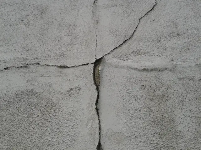 Ground Up Foundation Repair, Waterproofing and Concrete Leveling inspecting a prominent concrete wall crack indicating struct