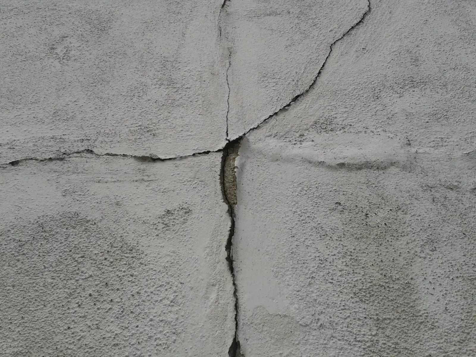 A prominent crack in a foundation wall indicating structural movement.