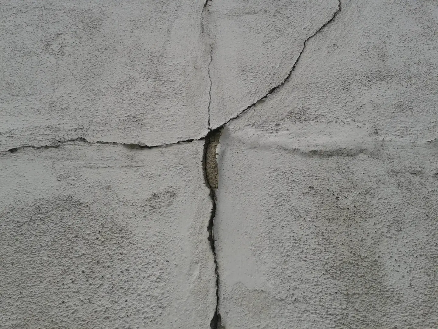 A prominent crack in a foundation wall indicating structural movement.