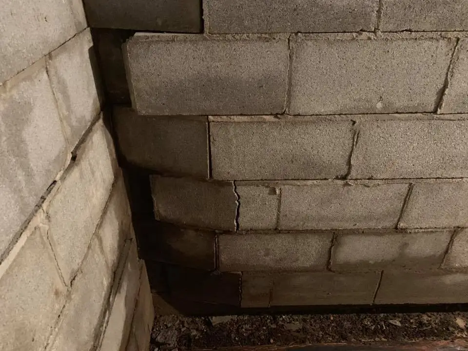 A severely bowing concrete block basement wall.