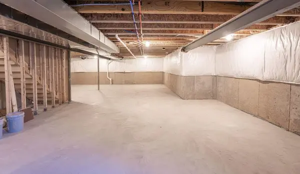 Ground Up Foundation Repair, Waterproofing and Concrete Leveling installing basement wall vapor barriers for moisture