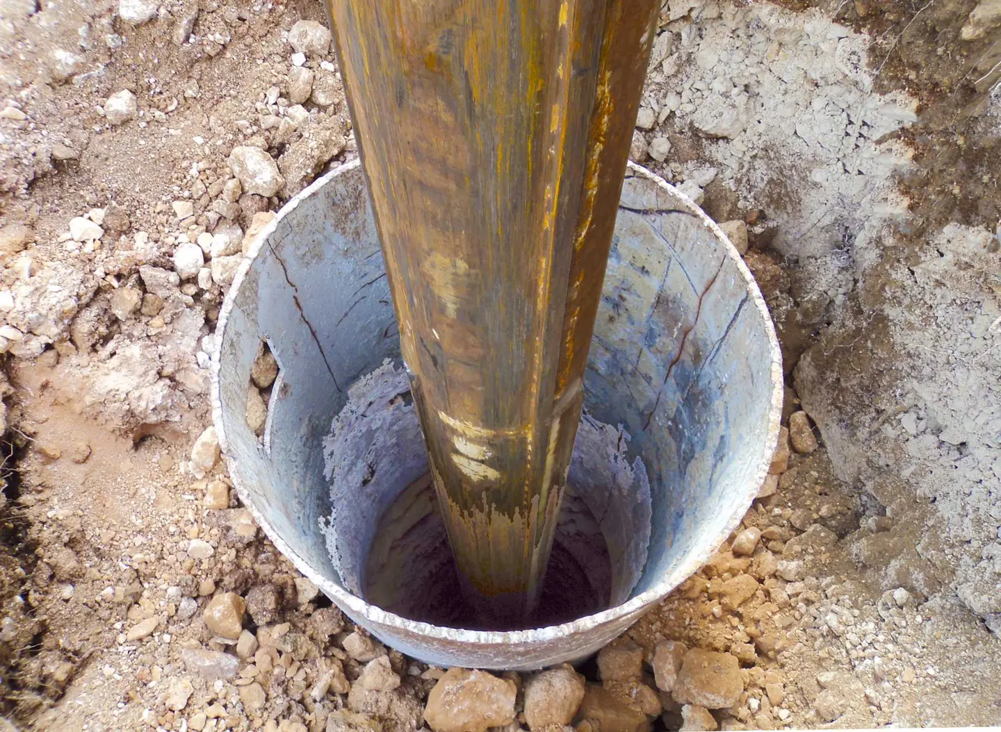 A foundation pier being installed for post and pier foundation repair.