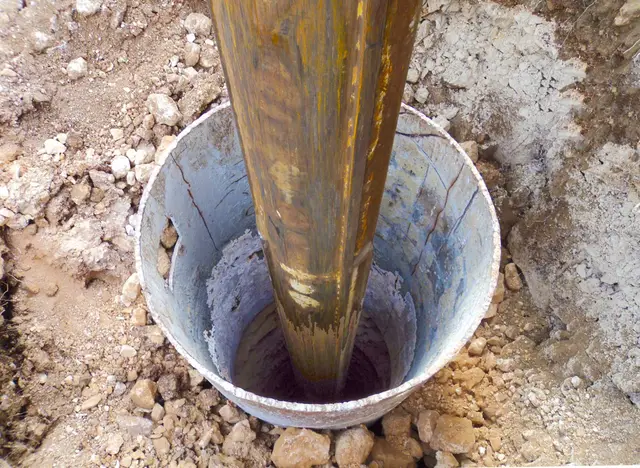 Ground Up Foundation Repair, Waterproofing and Concrete Leveling installing a foundation pier for post and pier foundation re