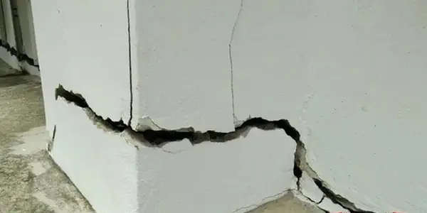 Ground Up Foundation Repair, Waterproofing and Concrete Leveling inspecting severe bowing wall and structural cracks on an ex