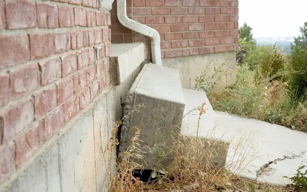 Sunken concrete steps that need lifting and leveling.