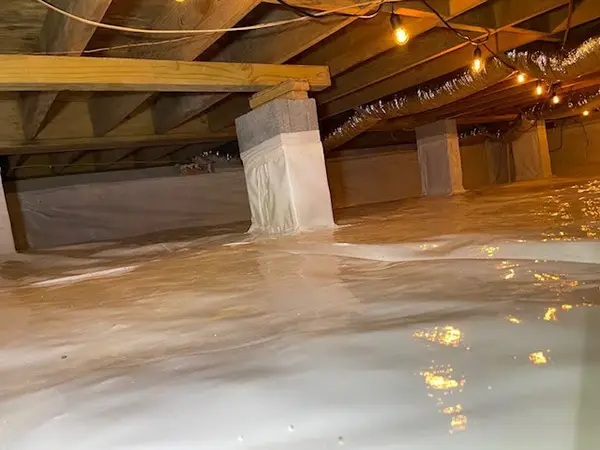 Ground Up Foundation Repair, Waterproofing and Concrete Leveling installing a clean white vapor barrier in an encapsulated cr