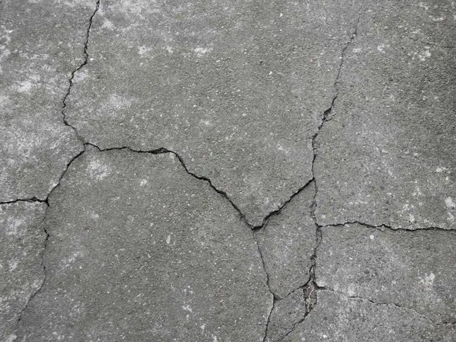 Ground Up Foundation Repair, Waterproofing and Concrete Leveling inspecting concrete floor cracks in a driveway or patio surf
