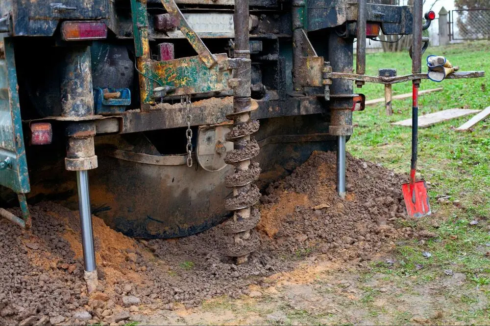 Ground Up crew performing foundation repair with a heavy duty drilling rig.