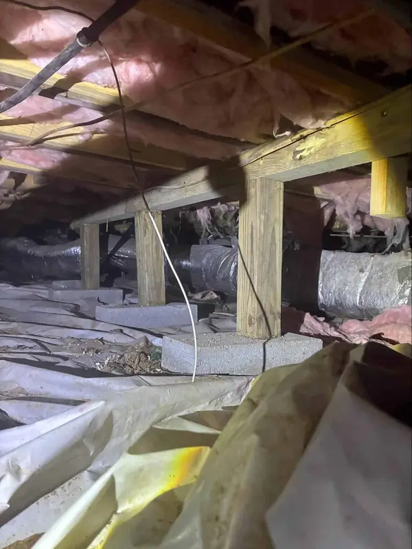 Ground Up Foundation Repair, Waterproofing and Concrete Leveling installing vapor barrier and insulation in a crawl space wit