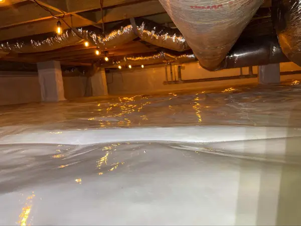 Ground Up Foundation Repair, Waterproofing and Concrete Leveling installing a CleanSpace vapor barrier in a crawl space.