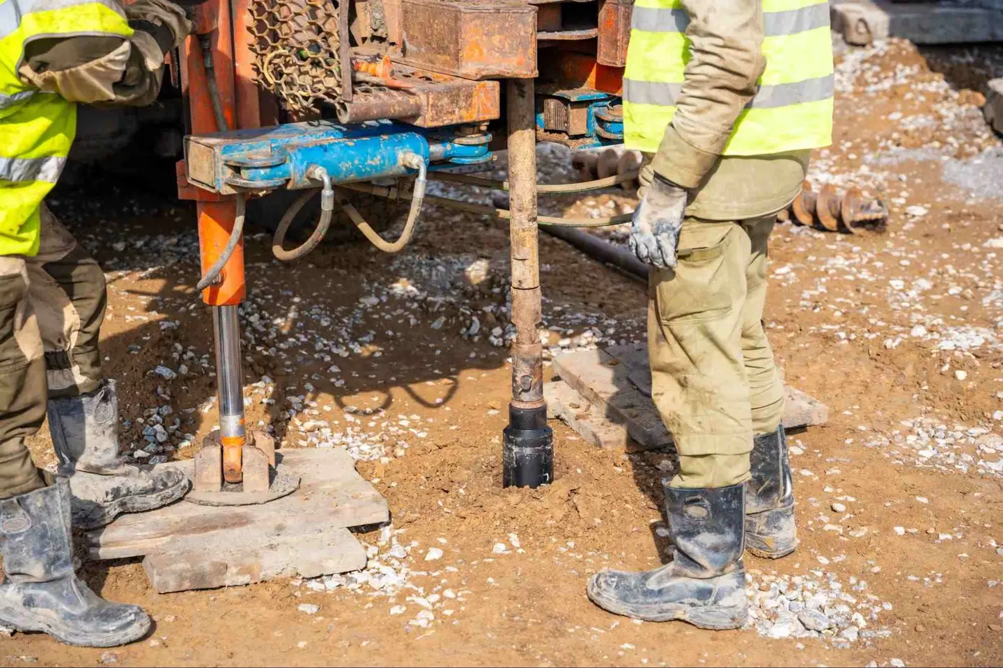 Ground Up Foundation Repair, Waterproofing and Concrete Leveling installing helical piers with a rotary drive head