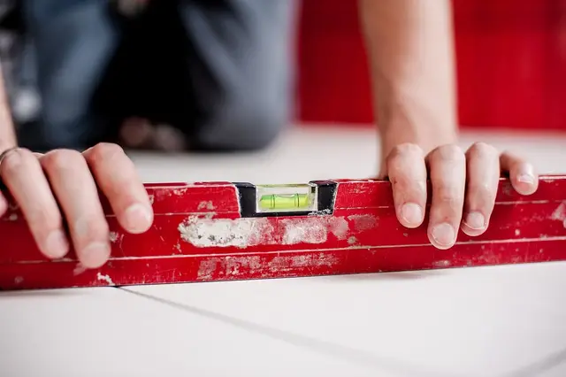A technician checking the level of a concrete slab.