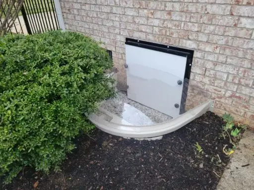 Ground Up Foundation Repair, Waterproofing and Concrete Leveling installing a new crawl space access well with a clear cover