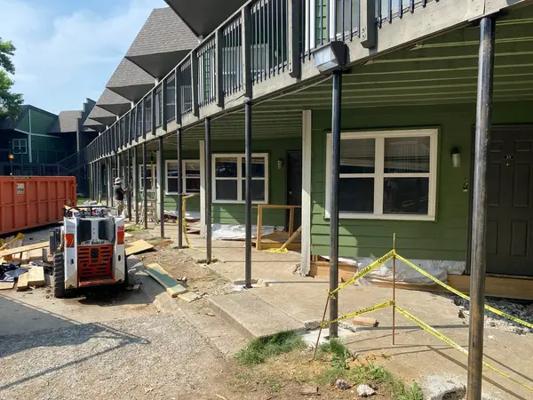 New steel support posts installed under second story decks at a multi unit building.