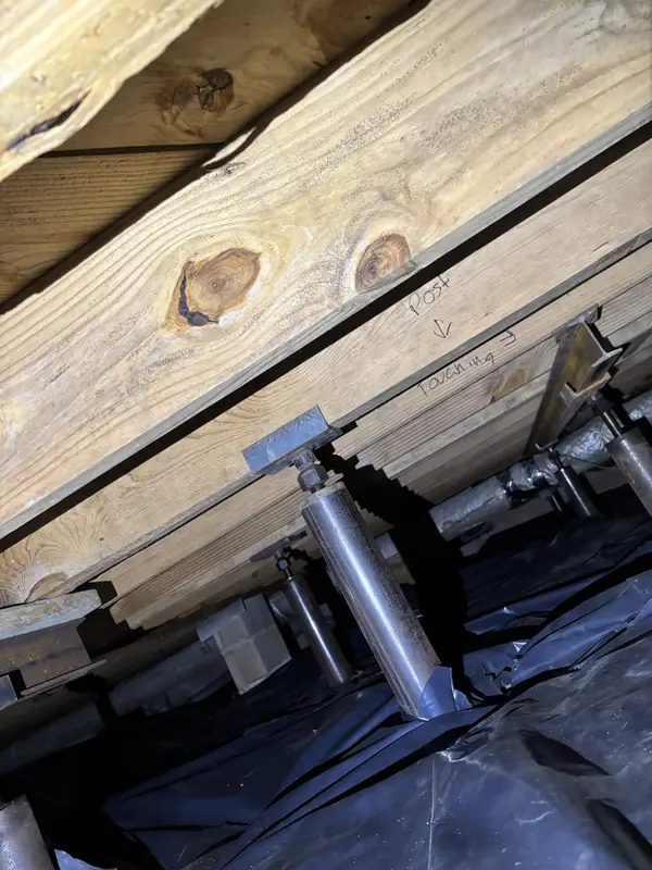 Ground Up Foundation Repair, Waterproofing and Concrete Leveling installing adjustable smart jacks and vapor barrier