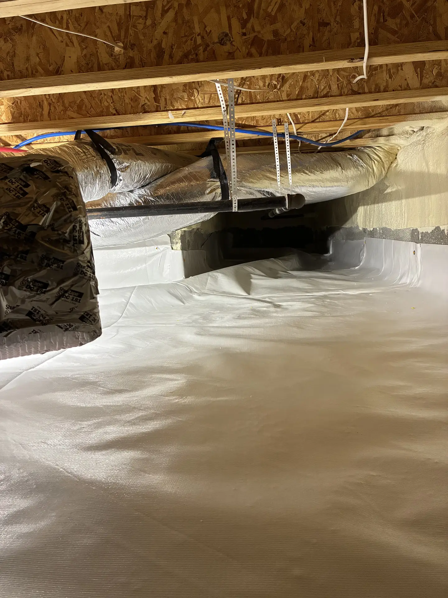 Ground Up Foundation Repair, Waterproofing and Concrete Leveling installing a full crawl space encapsulation system.